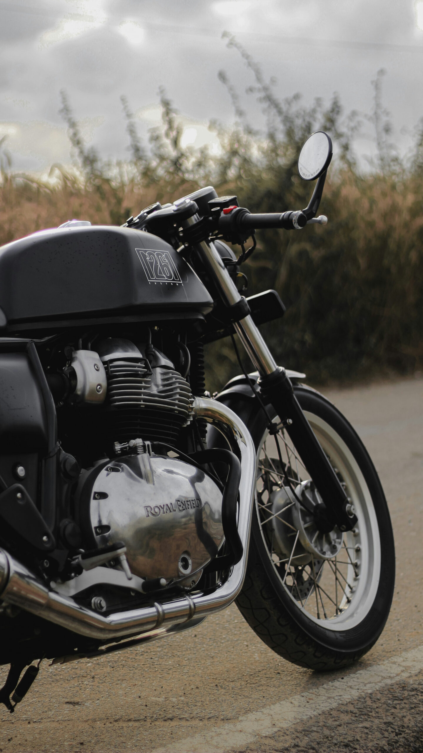 Black and silver motorcycle on brown dirt road during daytime