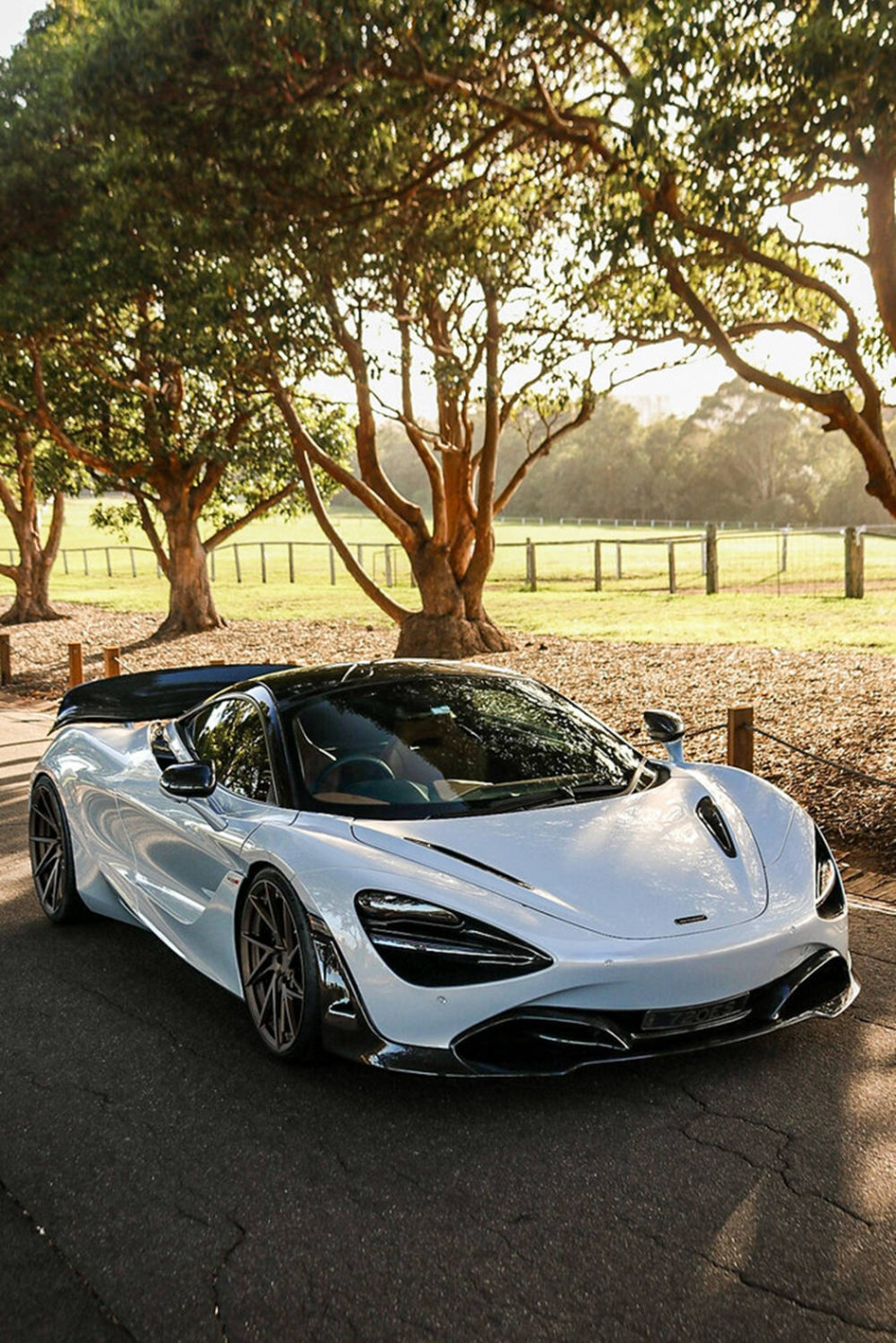 Download McLaren S White Car By Trees Phone Wallpaper