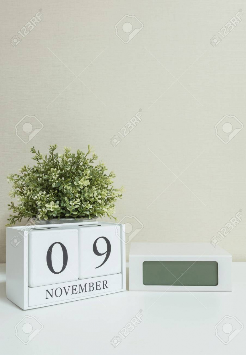 White Wooden Calendar With Black  November Word With Clock And